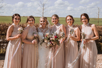 bridesmaids in blush dresses with their wand flowers