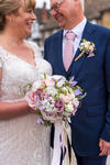 brides bouquet with bride and groom