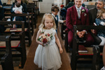 little bridesmaid with her posy of flowers walking down the aisle