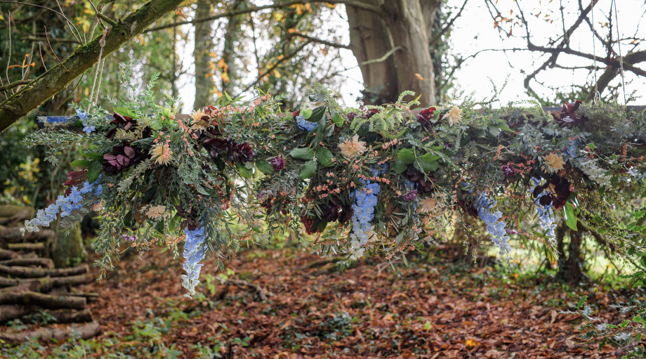 Autumnal scene with fresh flowers in a woodland setting for a wedding